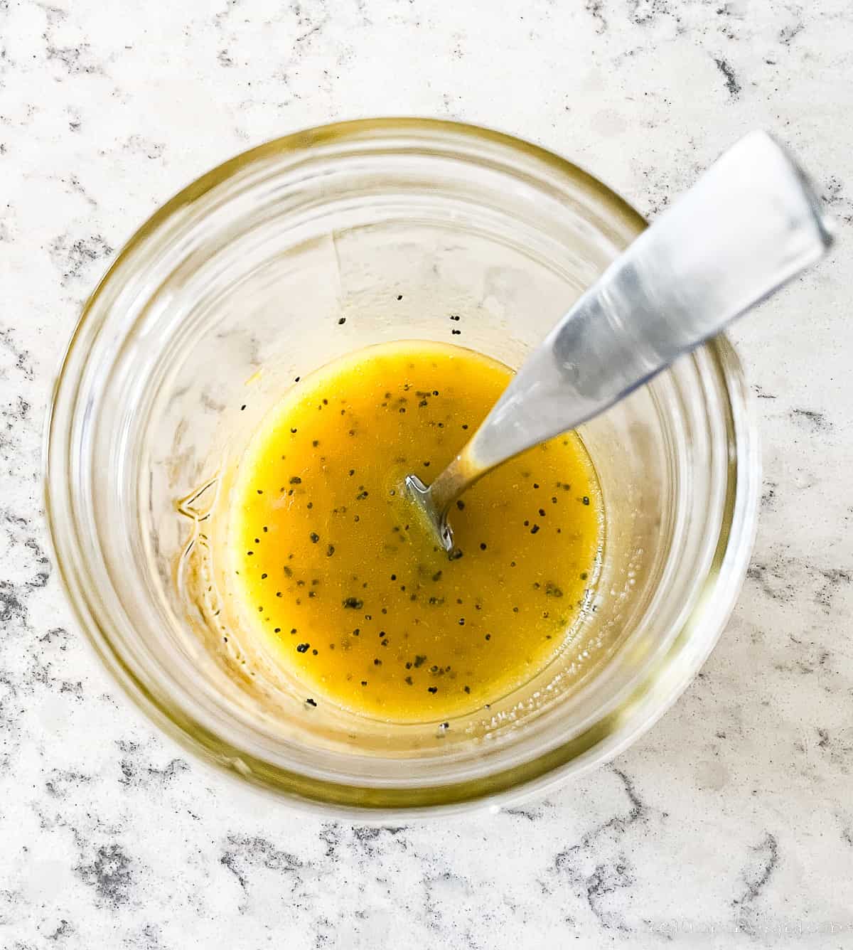 orange vinaigrette dressing in a mason jar