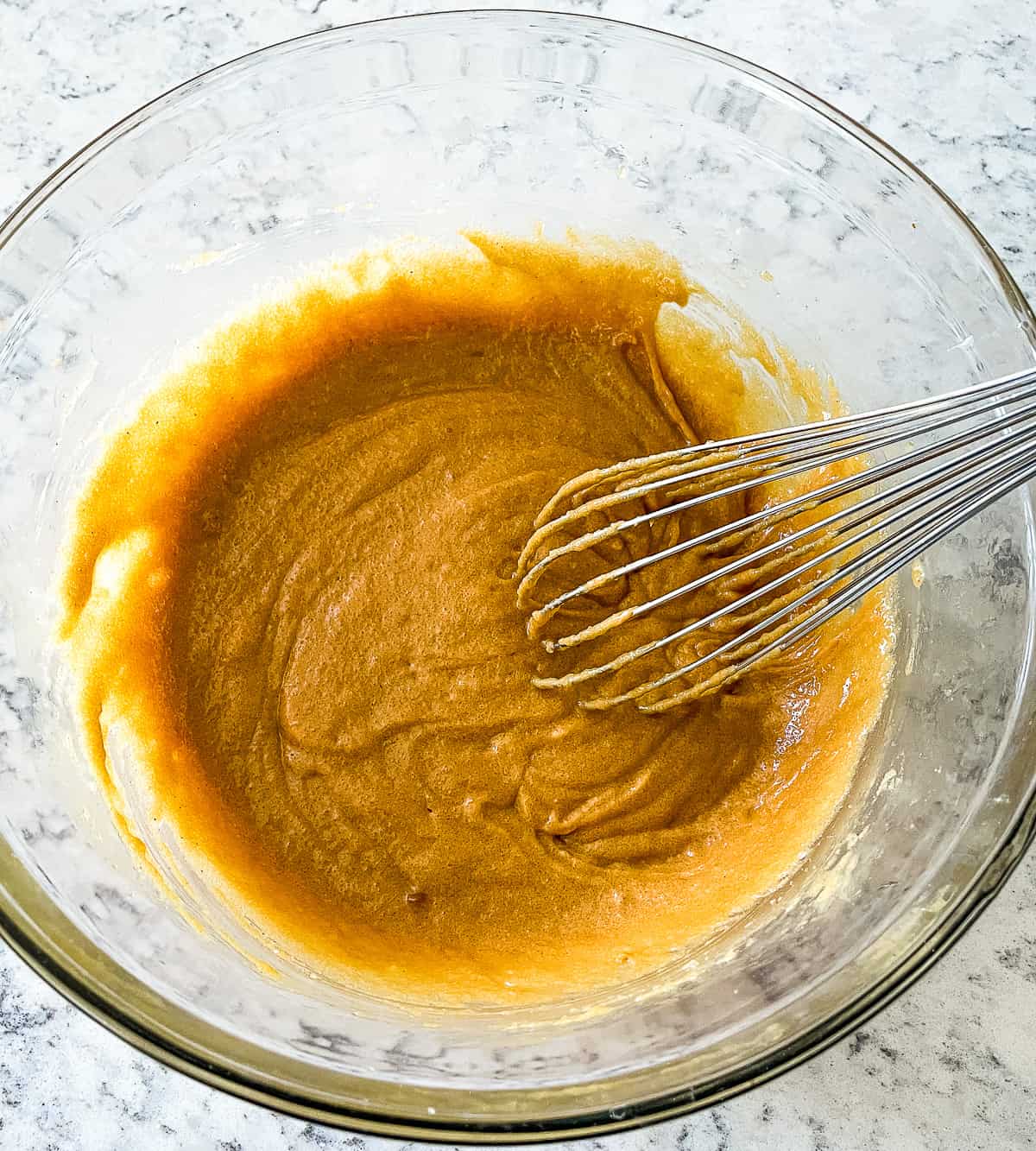 wet ingredients being whisked in a bowl