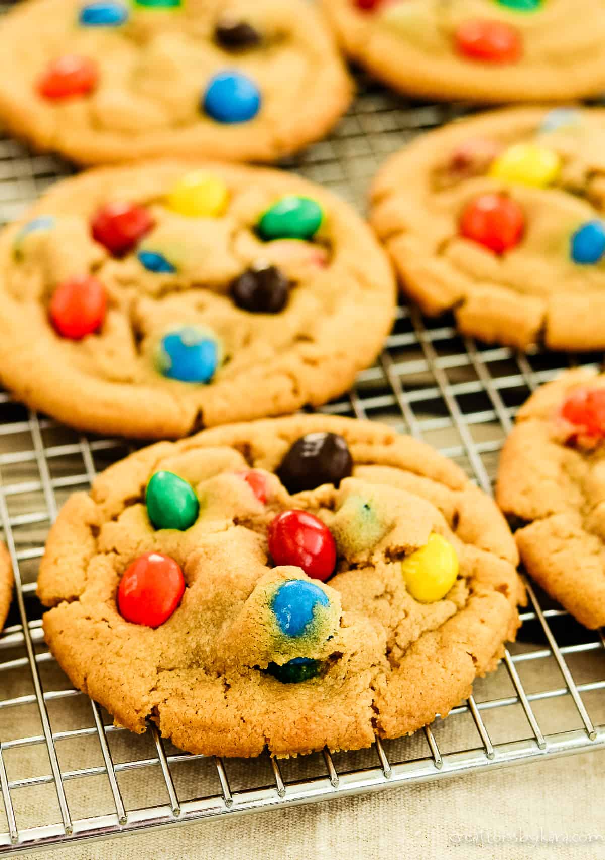 peanut M&M cookies cooling on a wire rack