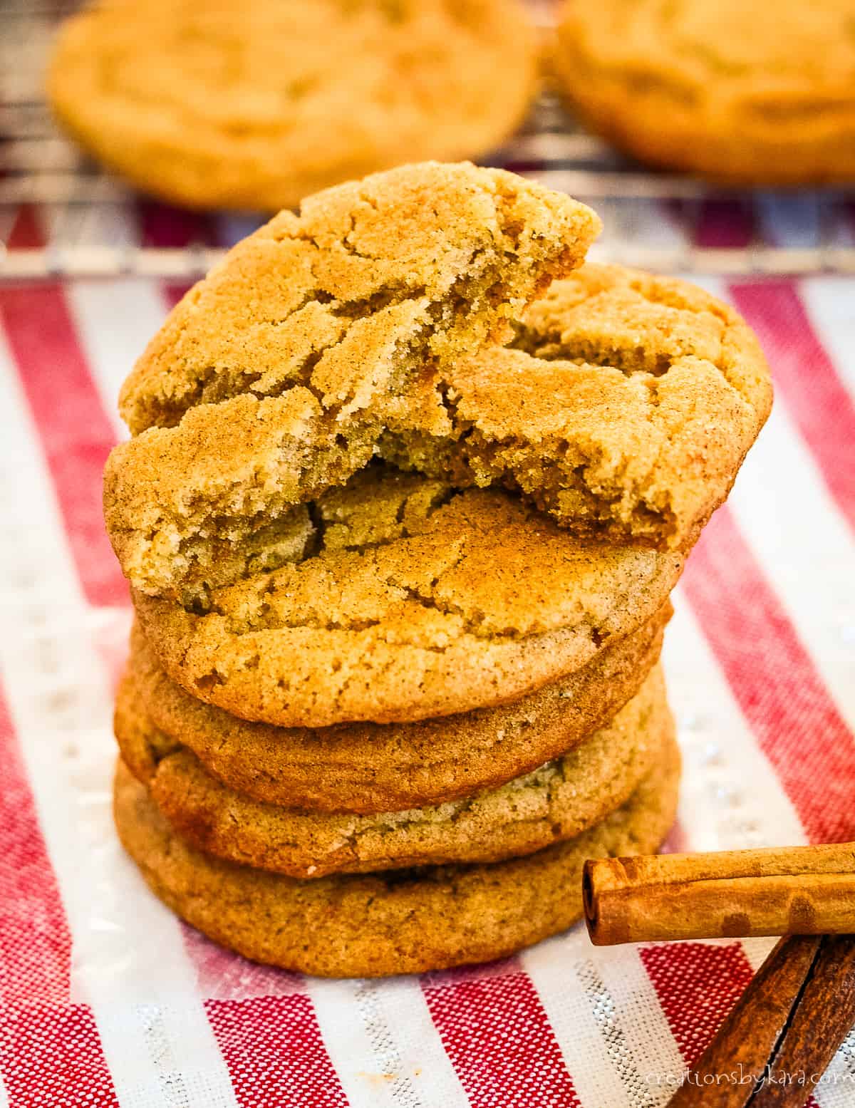 stack of chewy cinnamon cookies, one with a bite taken out of it