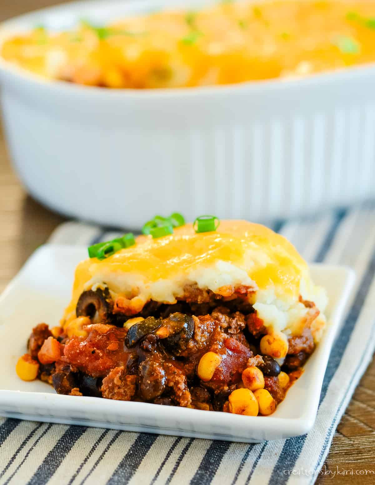 plate of mexican shepherd's pie with casserole dish in the background