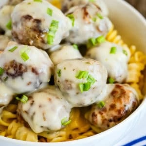 bowl of meatballs in cream sauce over pasta