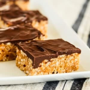 chocolate peanut butter rice krispie bars on a white tray