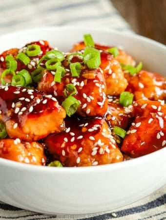 bowl of homemade general tso's chicken garnished with green onions