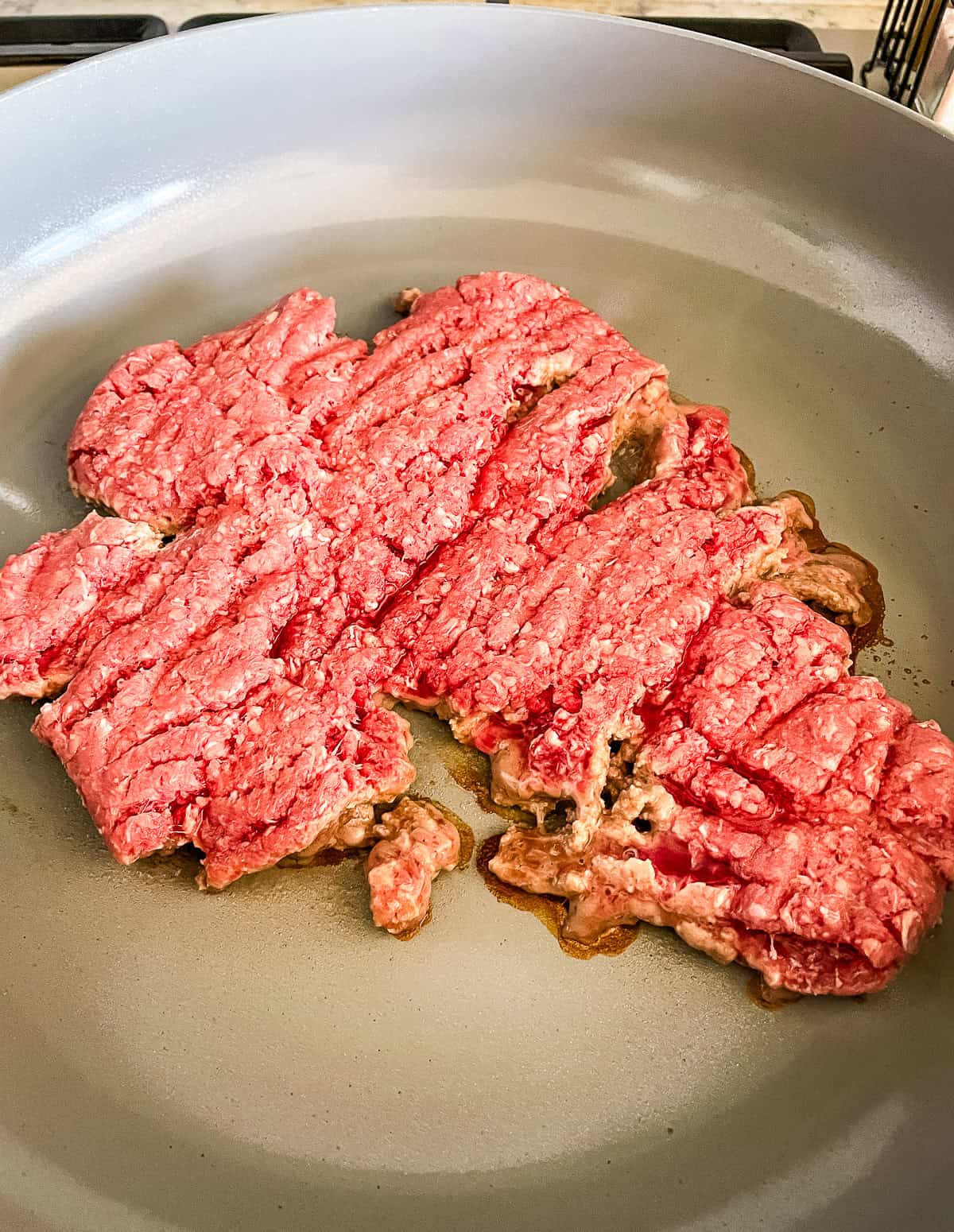 ground beef browning in a skillet