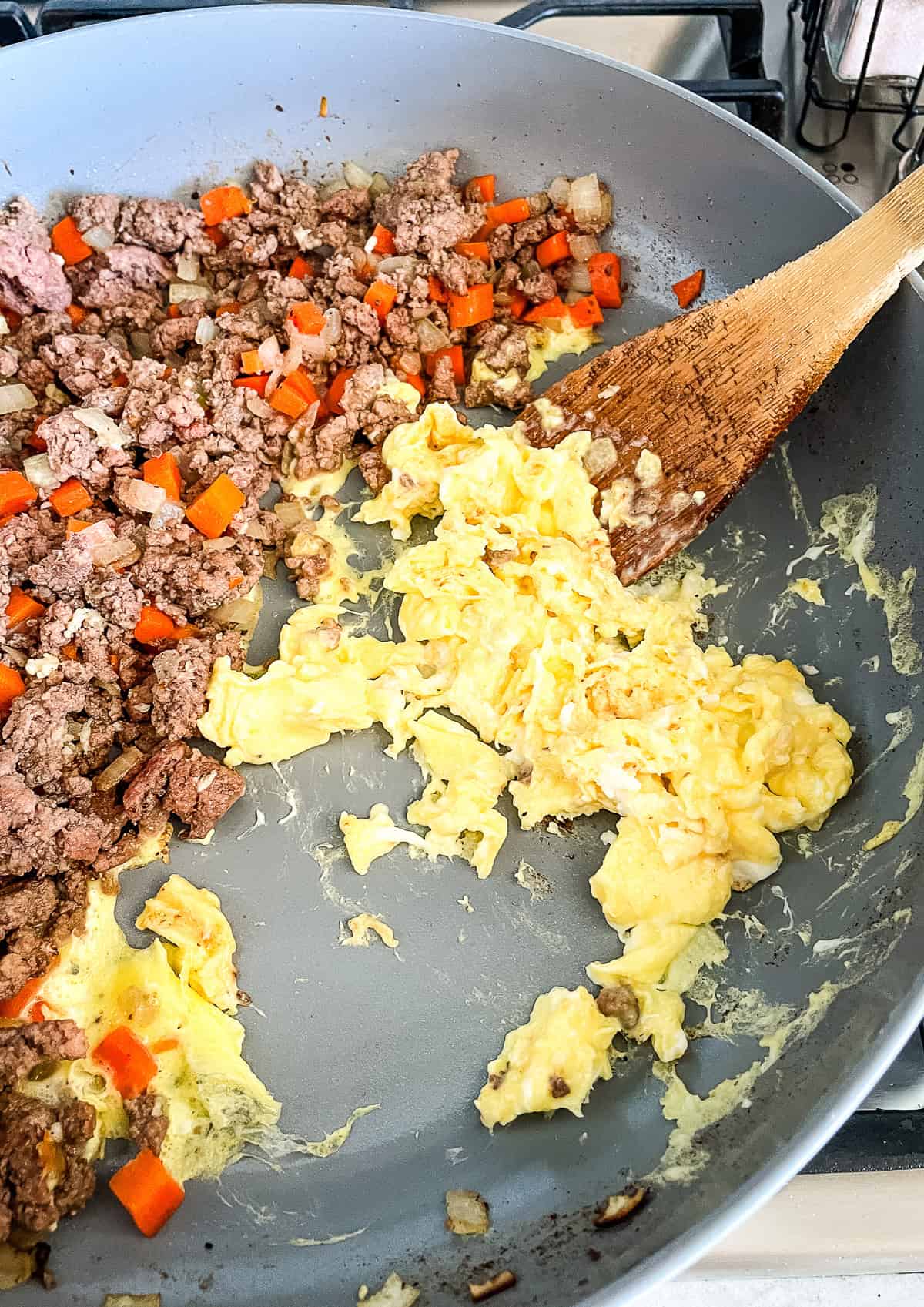 adding eggs to ground beef fried rice