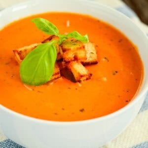 bowl of creamy tomato basil soup with croutons