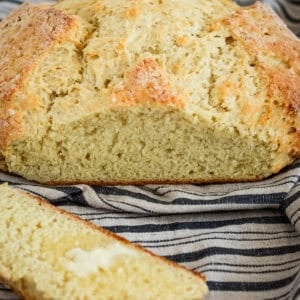 sliced warm loaf of moist Irish soda bread with butter