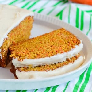 slices of carrot cake loaf with cinnamon cream cheese icing