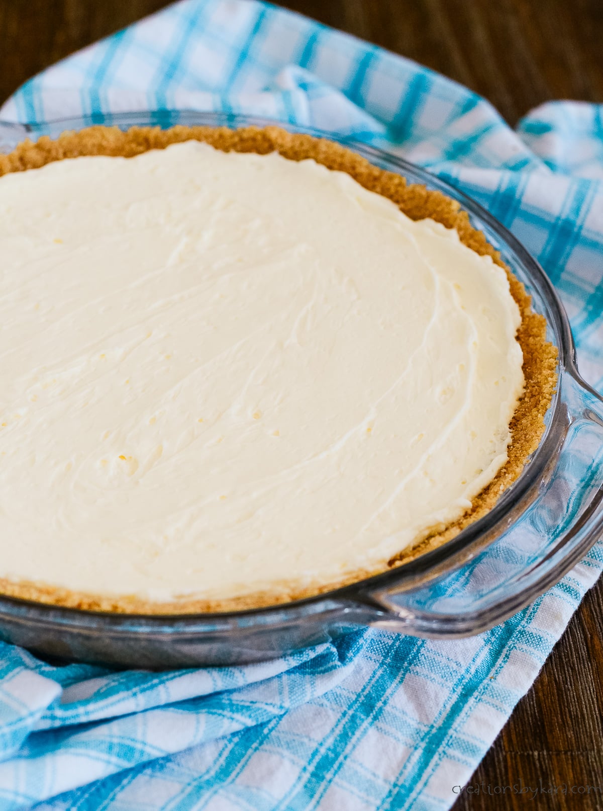 no bake cream cheese pie on a blue checked towel