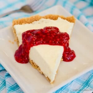 slice of no bake cream cheese pie with raspberry sauce