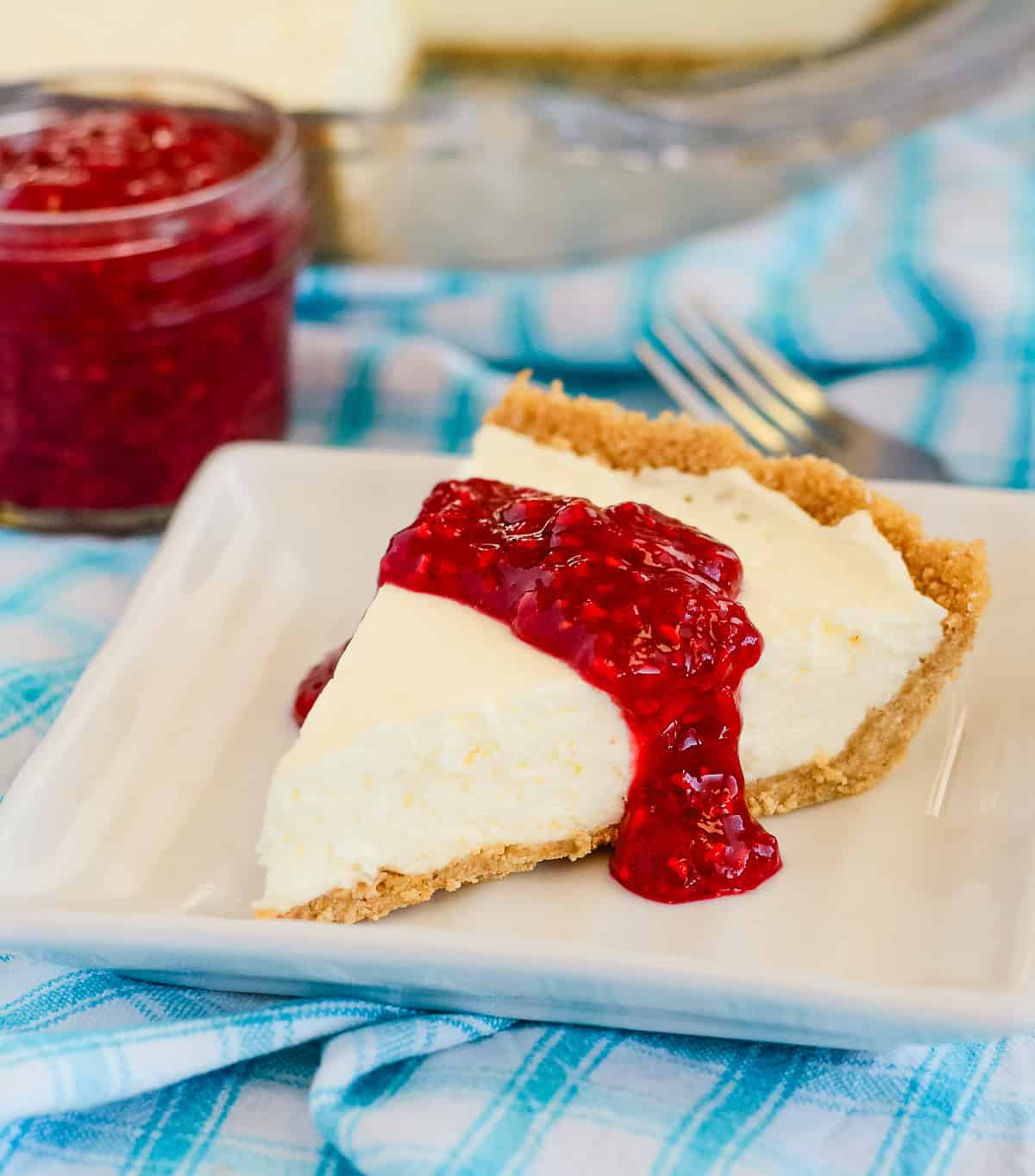 raspberry compote on a slice of cheesecake