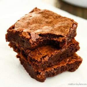 stack of coconut oil brownies with crackly tops