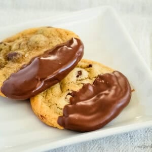 dipped chocolate chip cookies on a white plate