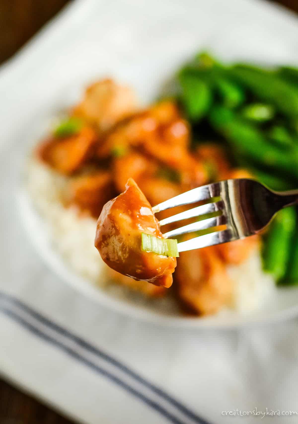 bite of peanut butter chicken on a fork