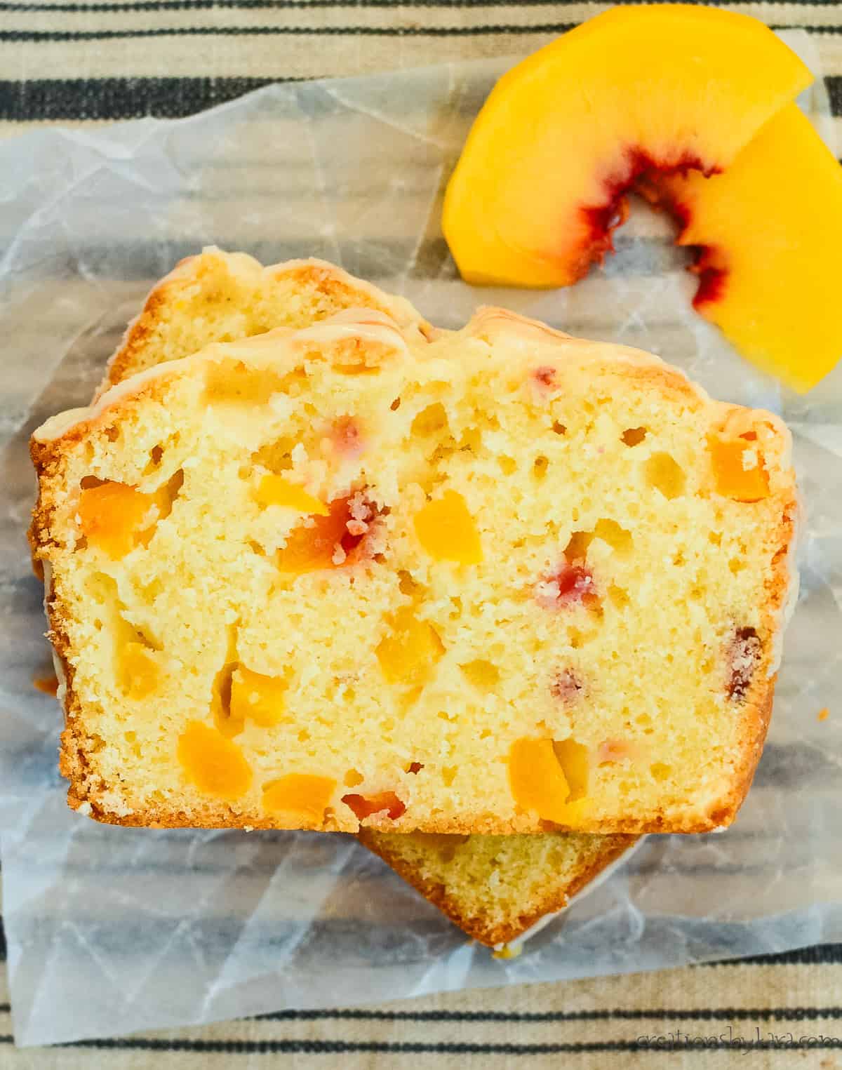 slice of peach bread with fresh peaches