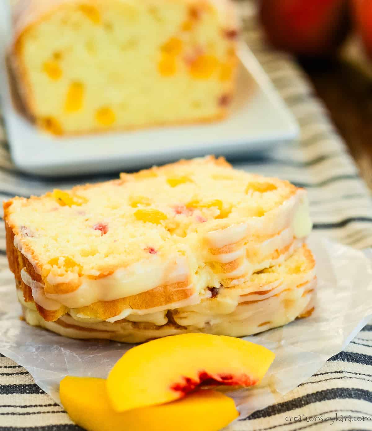 slices of glazed peach bread with a loaf in the background