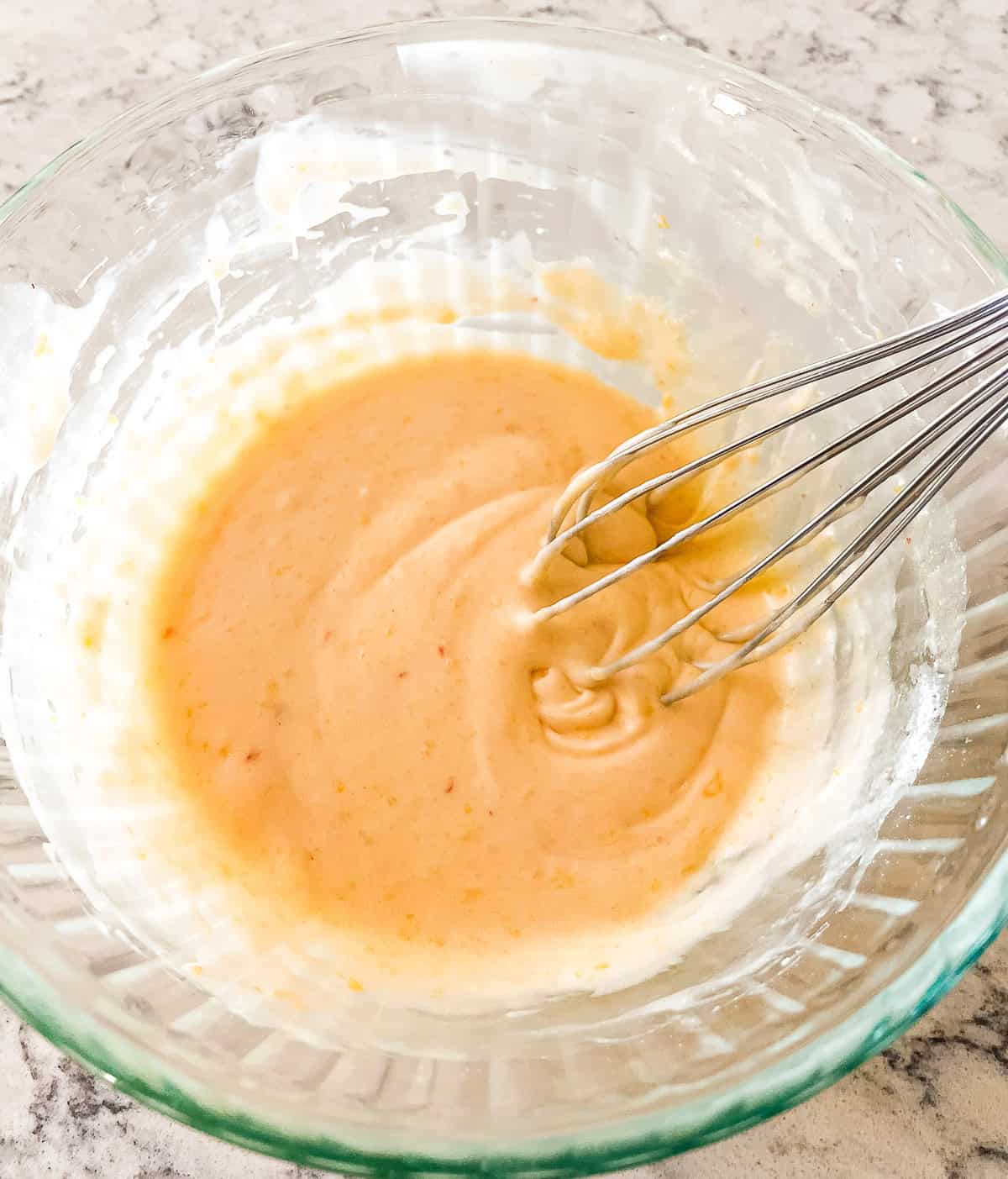 bowl of peach icing for cake