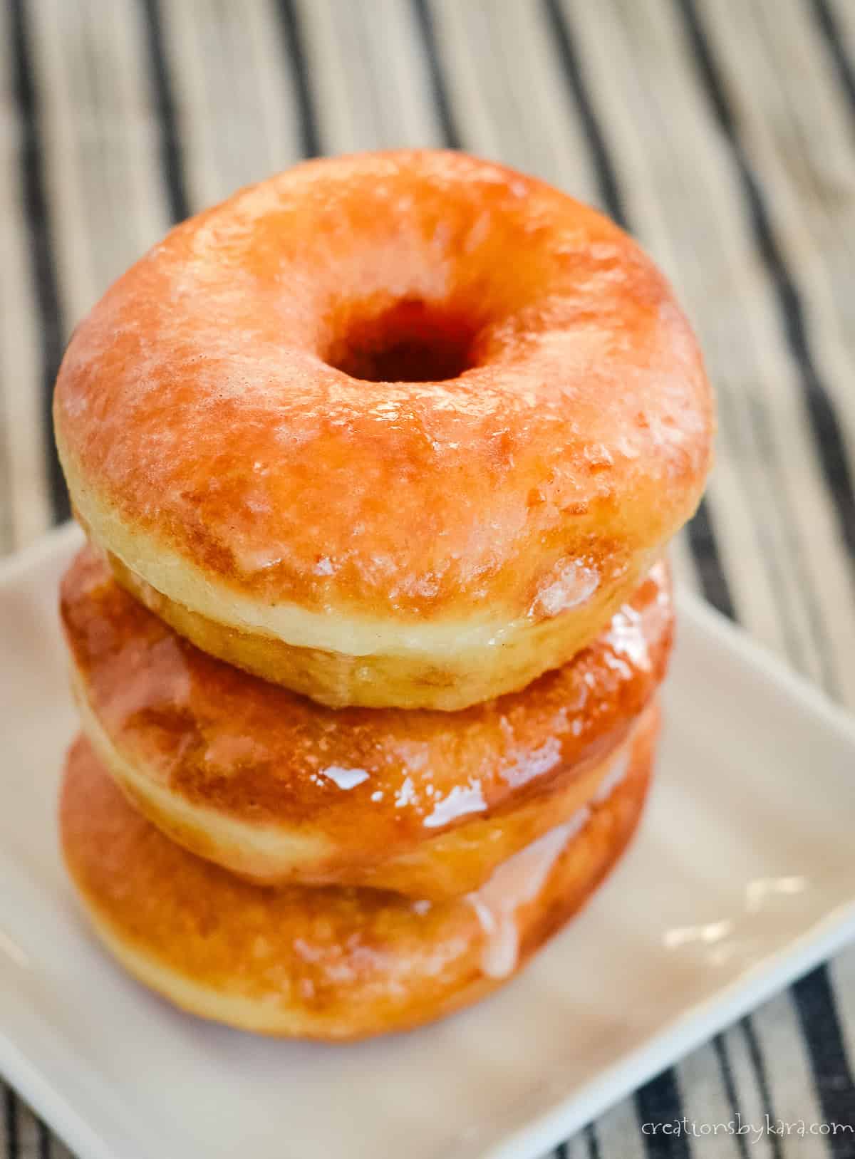 stack of homemade potato donuts on a square plate