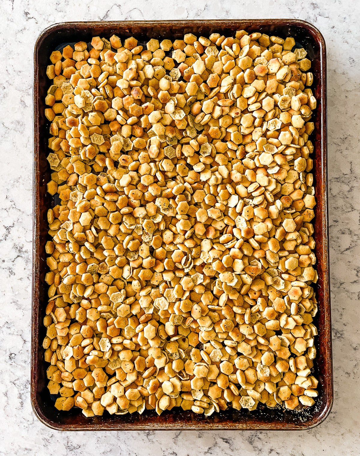 baked spiced oyster crackers on a baking sheet
