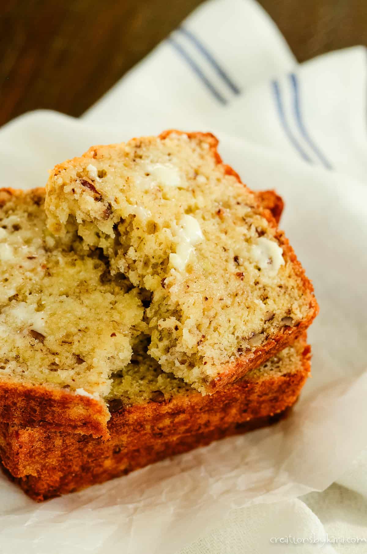 2 slices of banana bread, one with butter on it