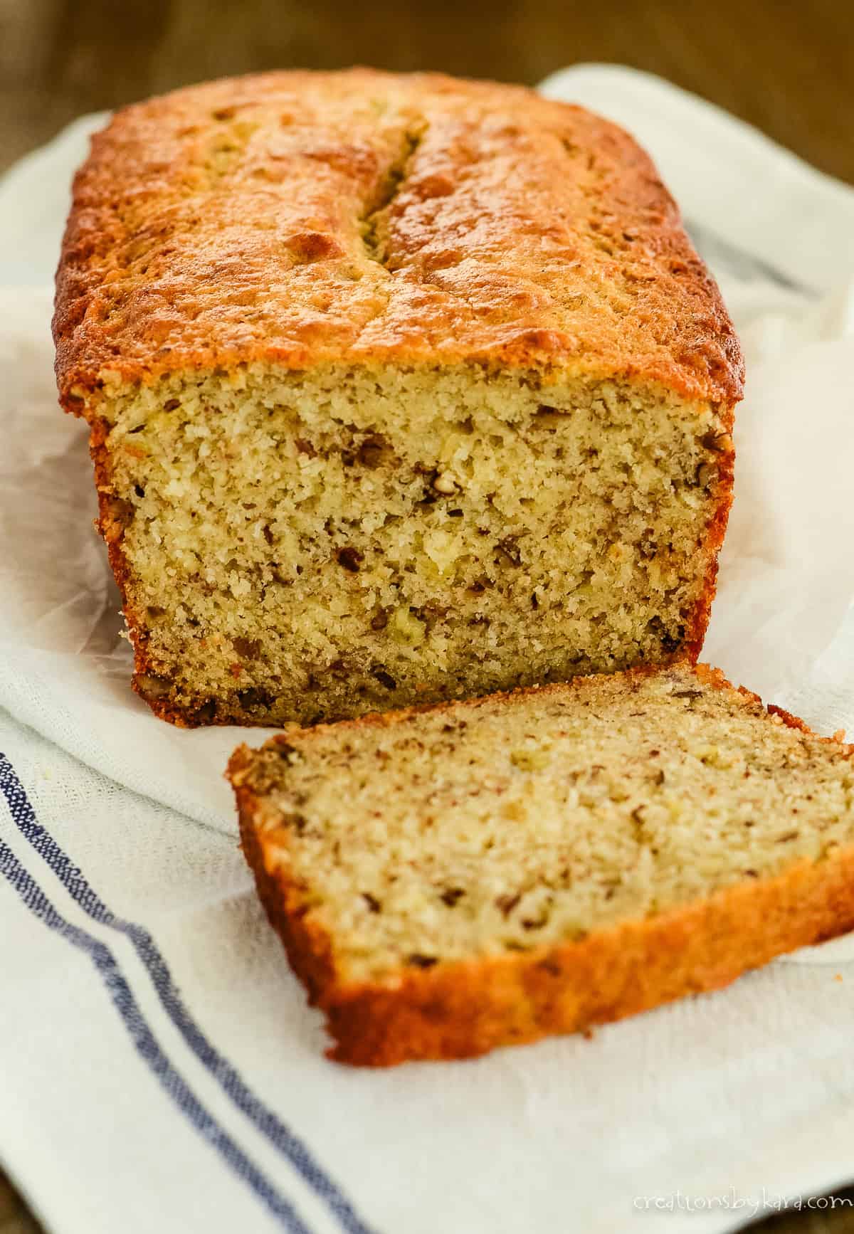 loaf of sliced banana bread on a tea towel