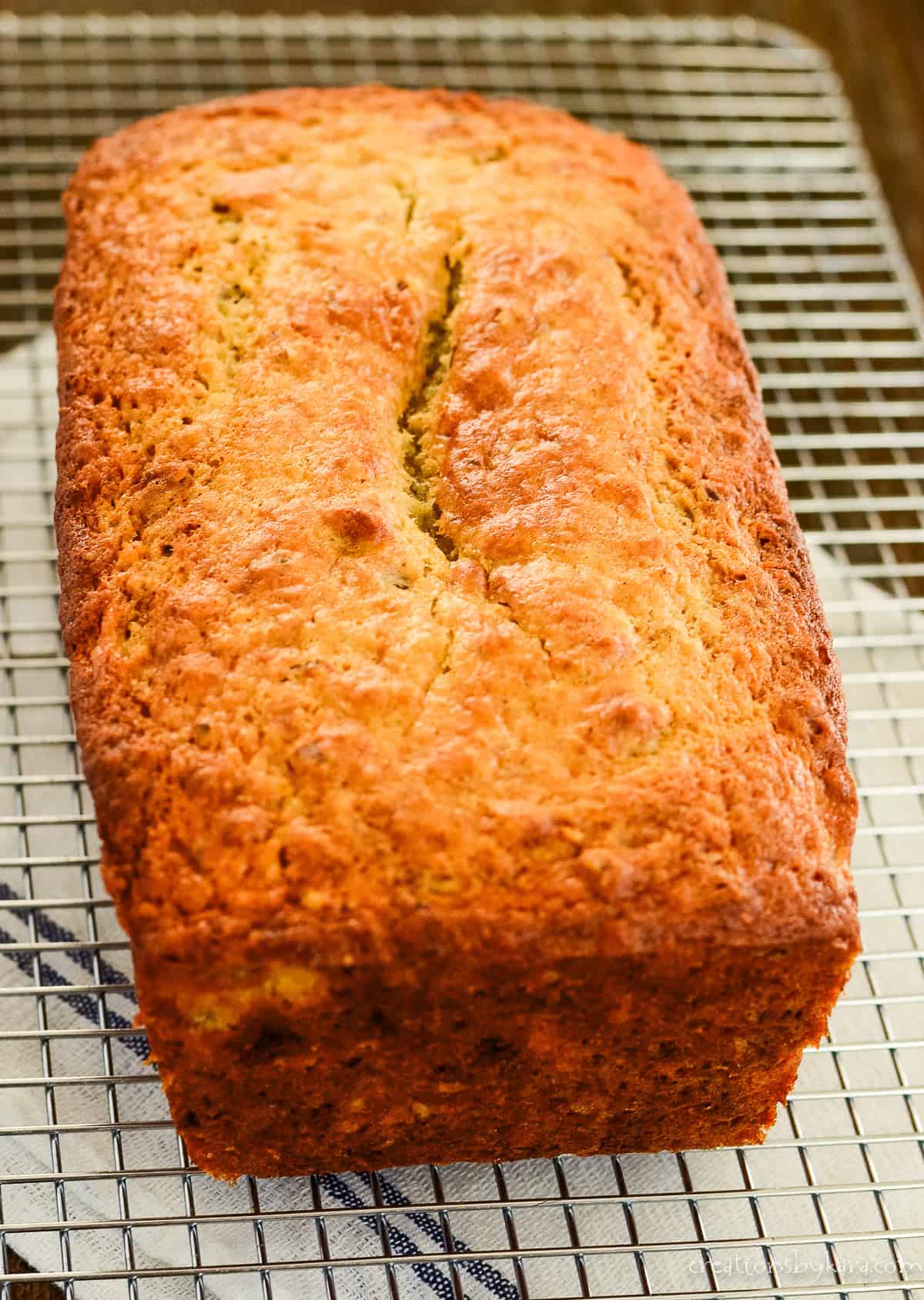 loaf of 2 banana banana bread cooling on a wire rack
