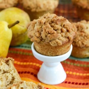 crumble pear muffin with pears in the background
