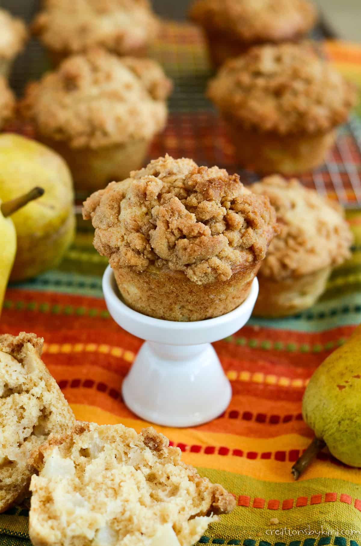 crumb topped pear muffin on a cupcake stand