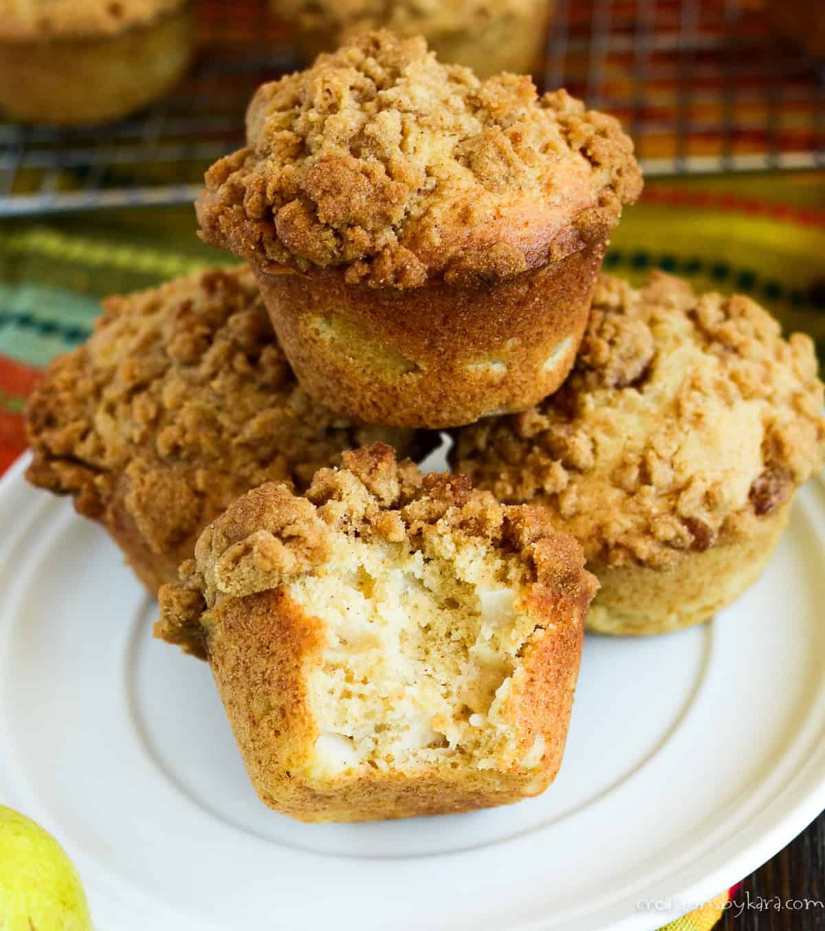 plate of pear muffins, one with a bite out of it