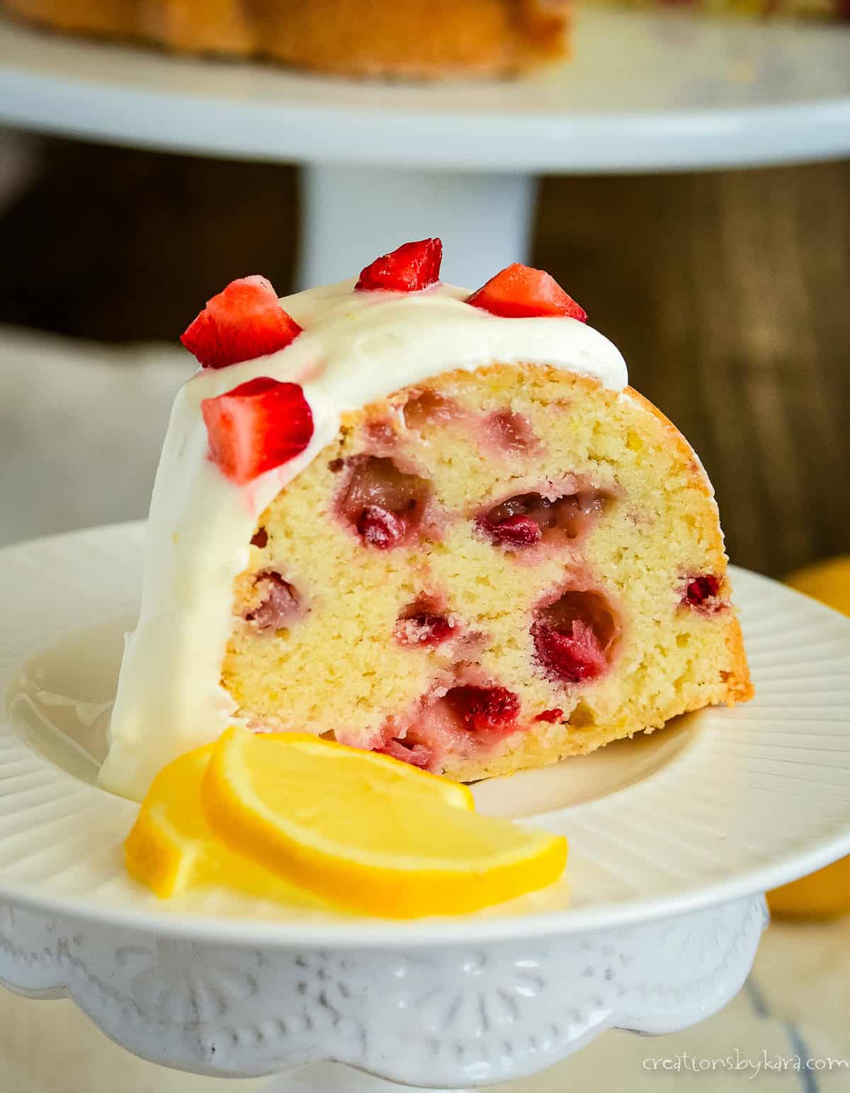 strawberry lemon cake on a plate with lemon slices