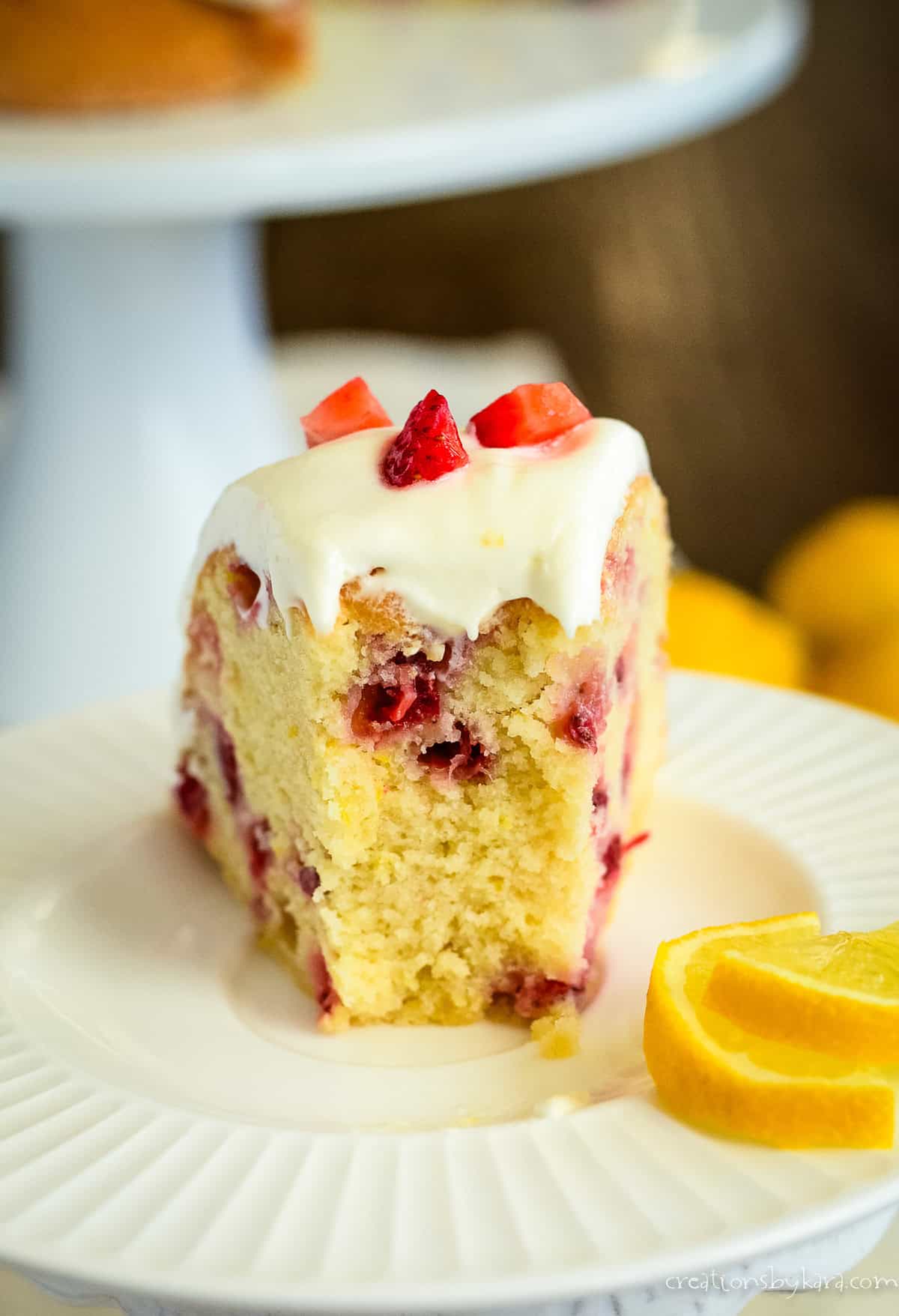 slice of strawberry lemonade cake with a bite taken out of it