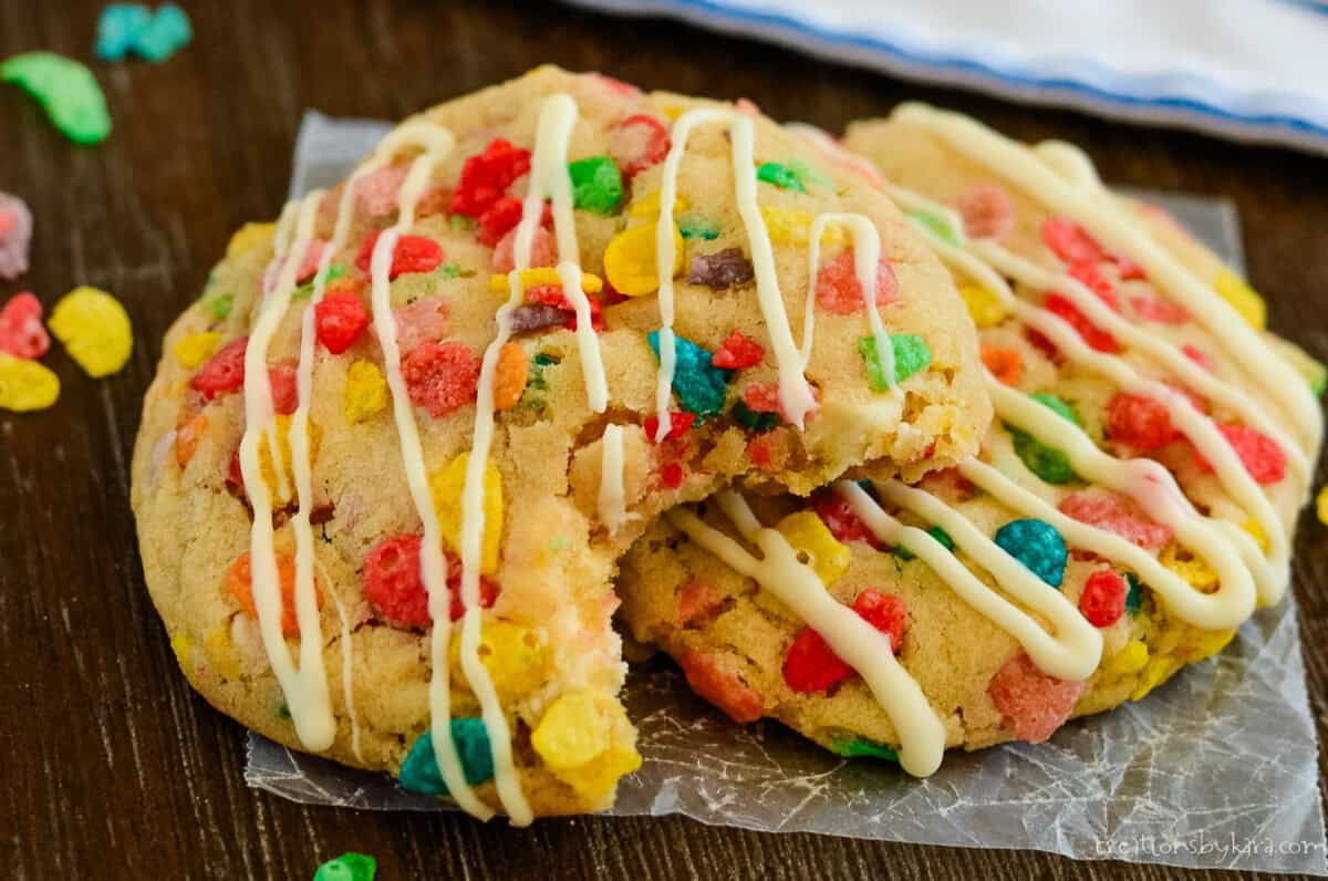 2 fruity pebbles cookies, one with a bite taken out of it