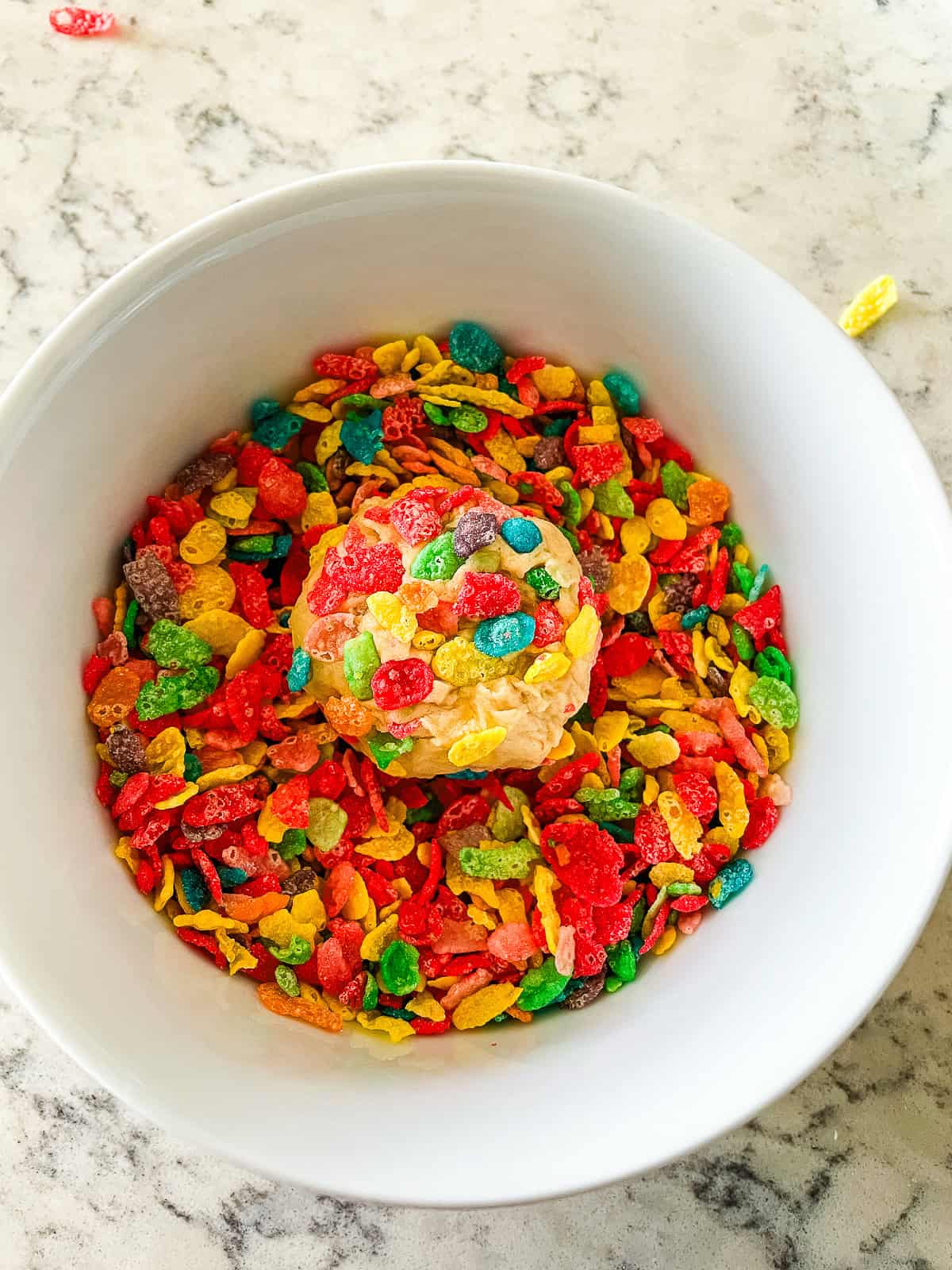 process shot- rolling cookie dough ball in cereal