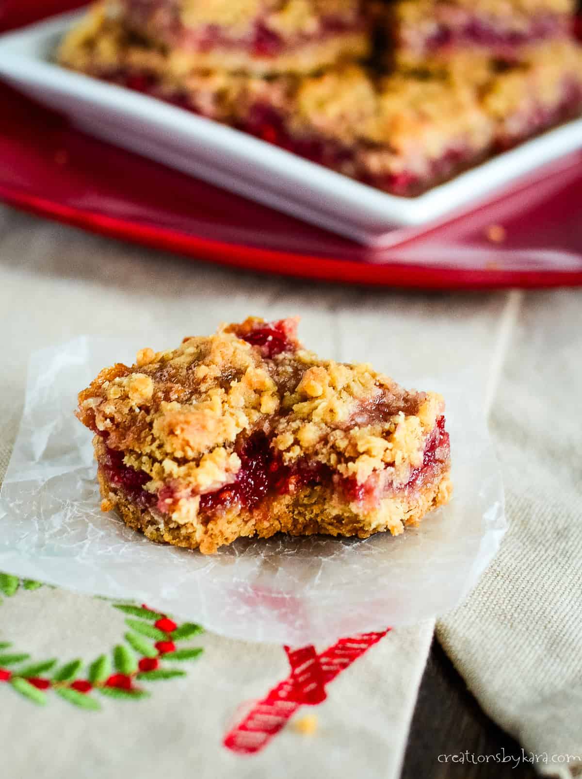 raspberry oatmeal bar with a bite taken out of it
