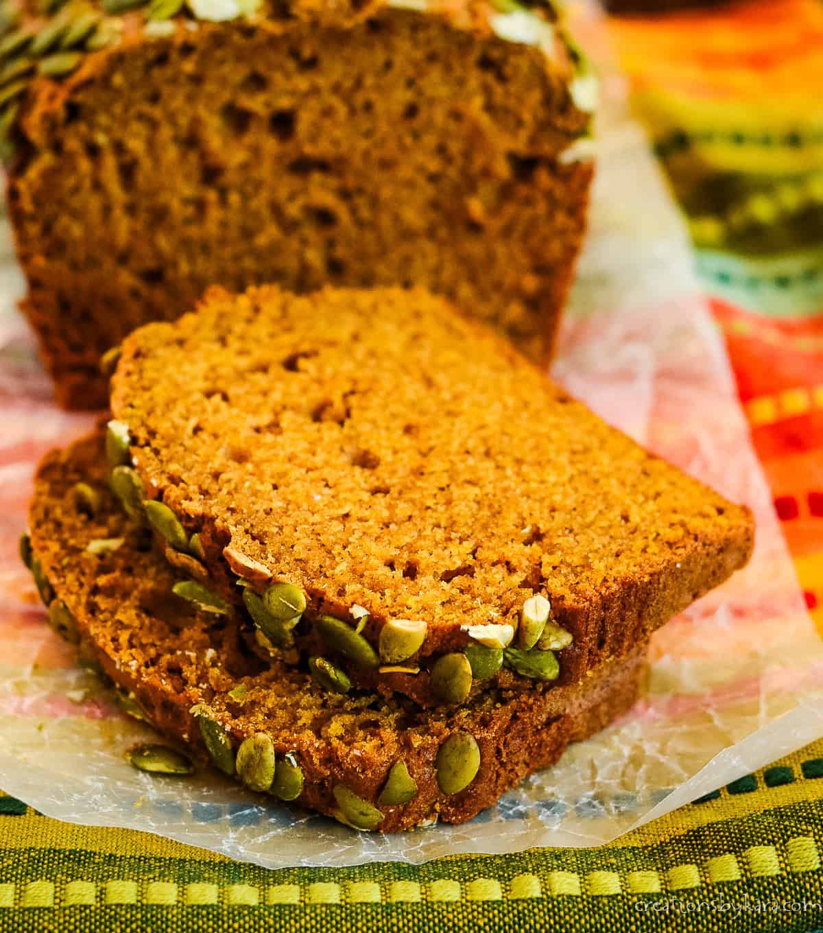 slices of pumpkin bread topped with pepitas