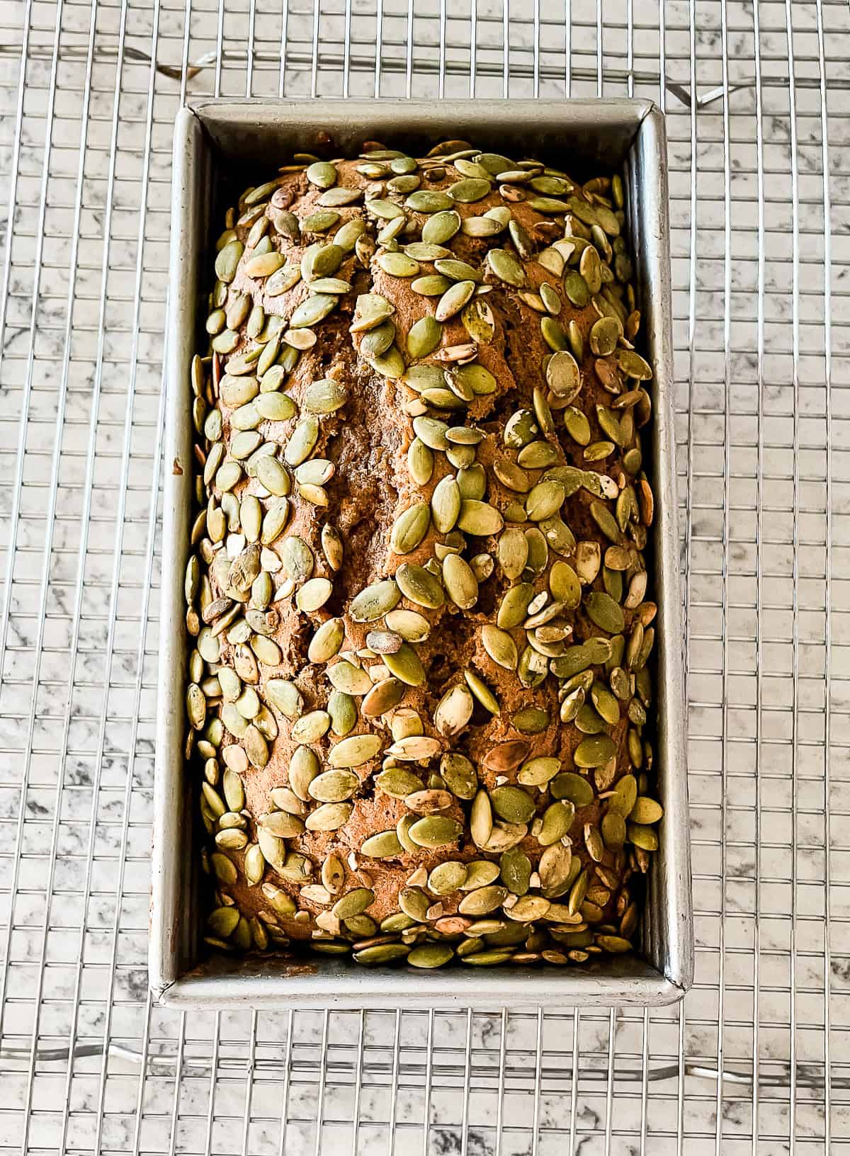 pan of pumpkin bread with pepitas